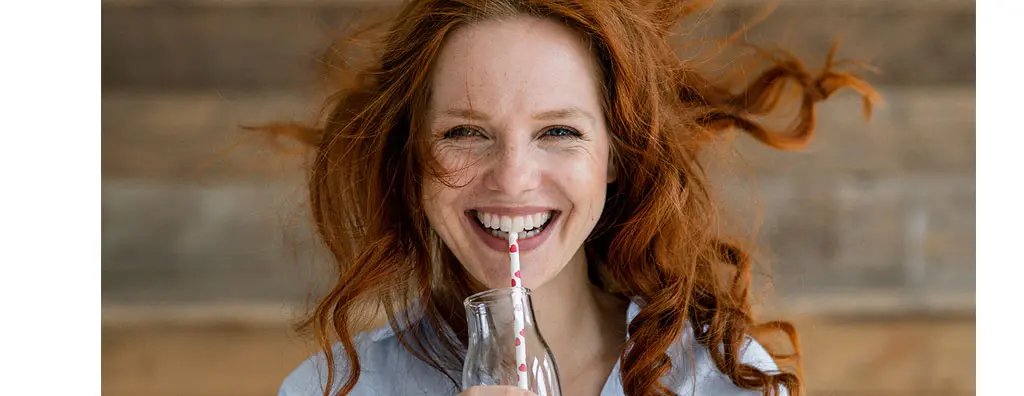 Young woman sipping a drink